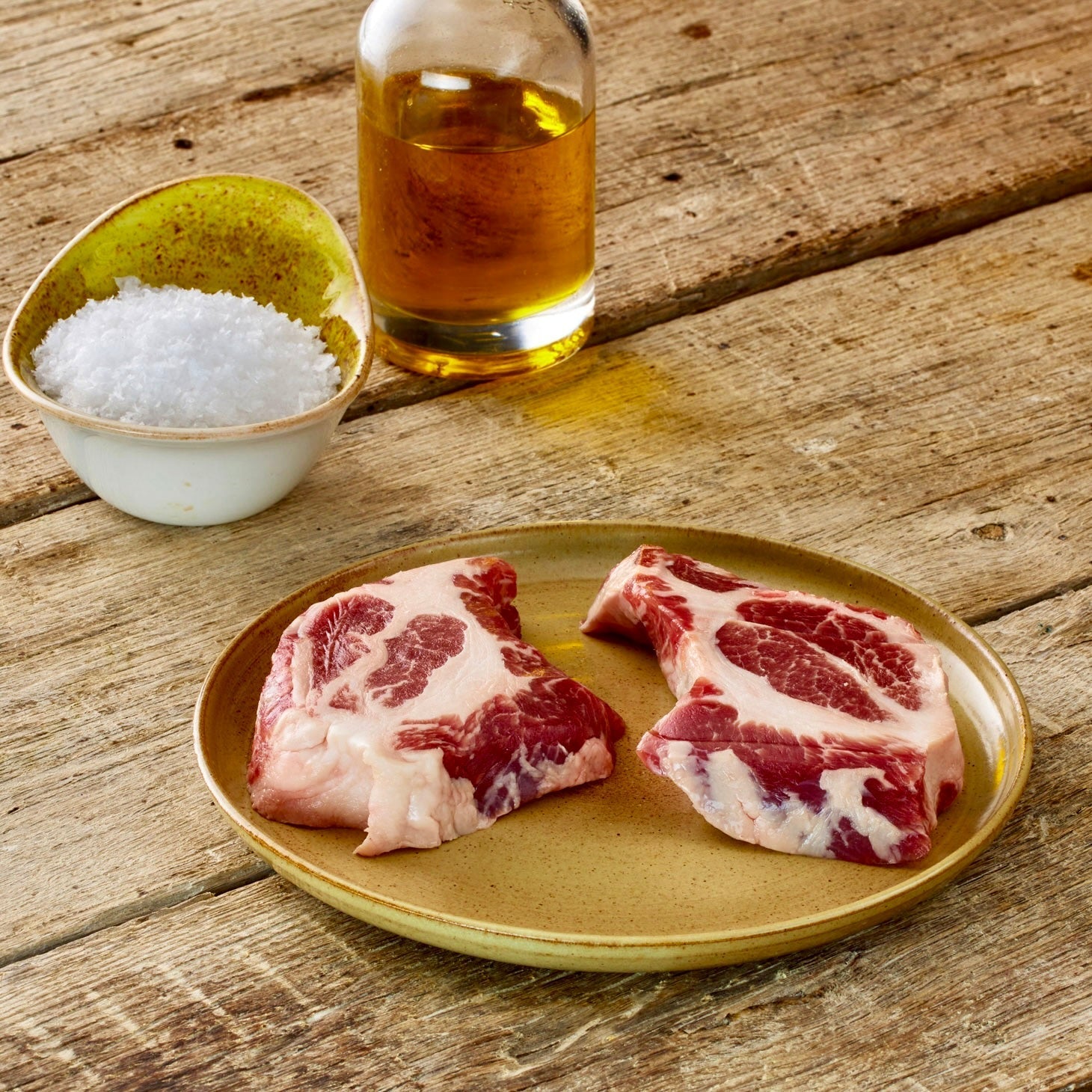two iberico pork collar steaks