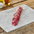 Raw Iberico pork tenderloin on a marble chopping board
